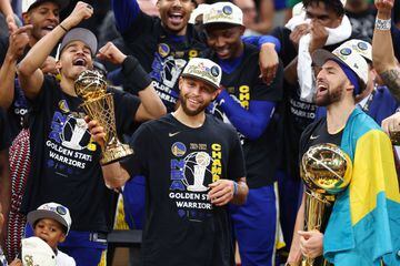Curry holds the Finals MVP trophy, as Klay Thompson cradles the Larry O'Brien Trophy.