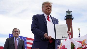 FILE - In this Sept. 8, 2020, file photo President Donald Trump holds a signed memorandum to expand the offshore drilling moratorium to Florida&#039;s Atlantic coast, Georgia and South Carolina after speaking at the Jupiter Inlet Lighthouse and Museum in 