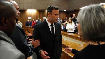 (FILES) This file photo taken on July 06, 2016 shows South African Paralympian athlete Oscar Pistorius (C) speaking with relatives as he leaves the High Court in Pretoria after being sentenced to six years in jail for murdering his girlfriend Reeva Steenk