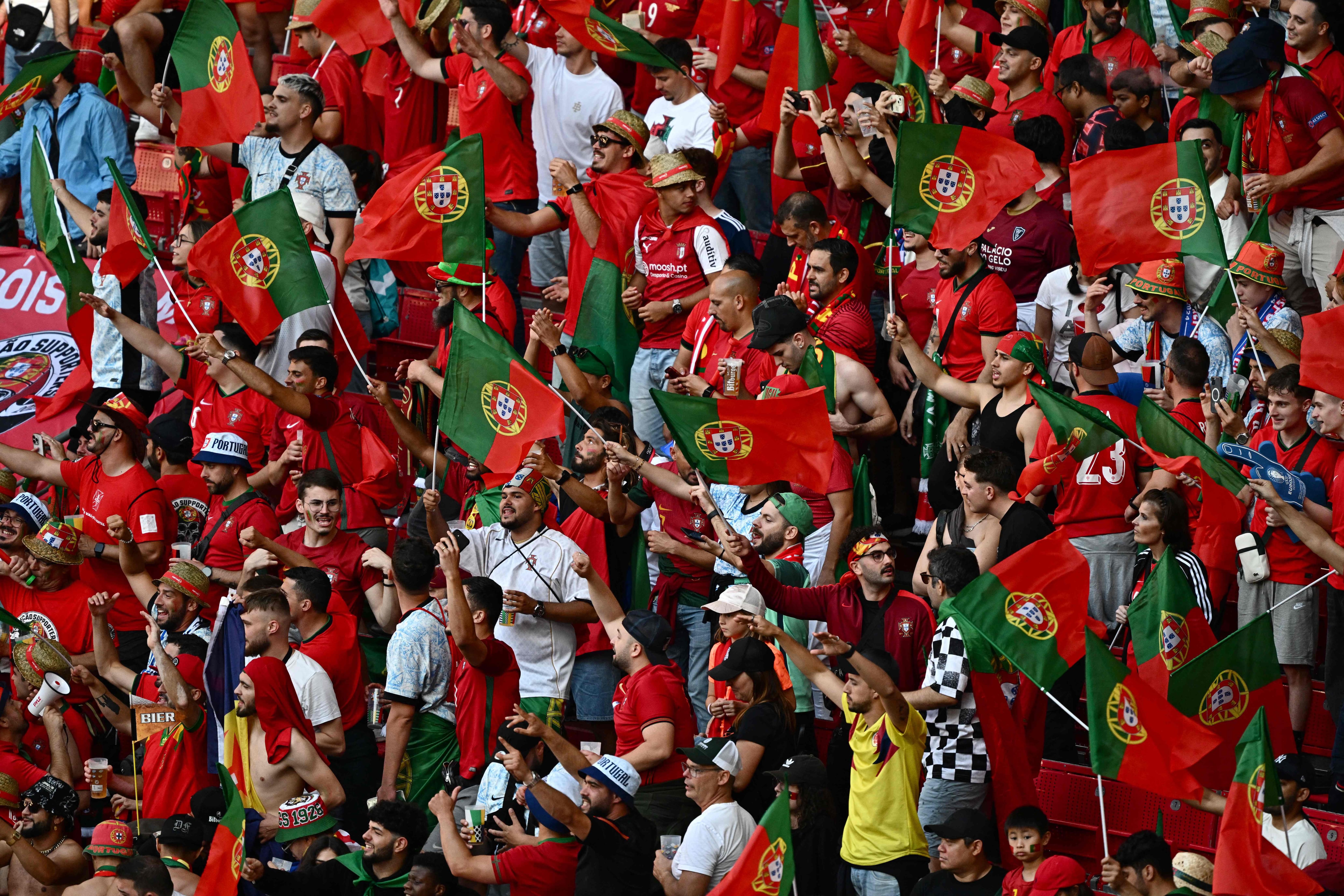 Supporters of Portugal wave flags in the tribune