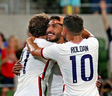 Jesés Ferreira (centre) is congratulated by Brenden Aaronson (left) and Christian Roldan after his fourth goal against Grenada.