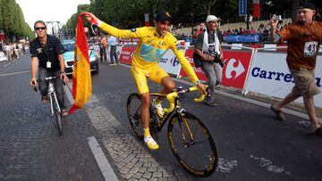 Alberto Contador, vestido de amarillo y llevando la bandera de Espa&ntilde;a, celebra en los Campos El&iacute;seos de Par&iacute;s su t&iacute;tulo de campe&oacute;n del Tour de Francia 2009.