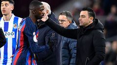 Barcelona's Spanish coach Xavi (R) greets Barcelona's French forward Ousmane Dembele as he leaves the pitch during the Copa del Rey (King's Cup), quarter final football match between FC Barcelona and Real Sociedad, at the Camp Nou stadium in Barcelona on January 25, 2023. (Photo by Pau BARRENA / AFP)