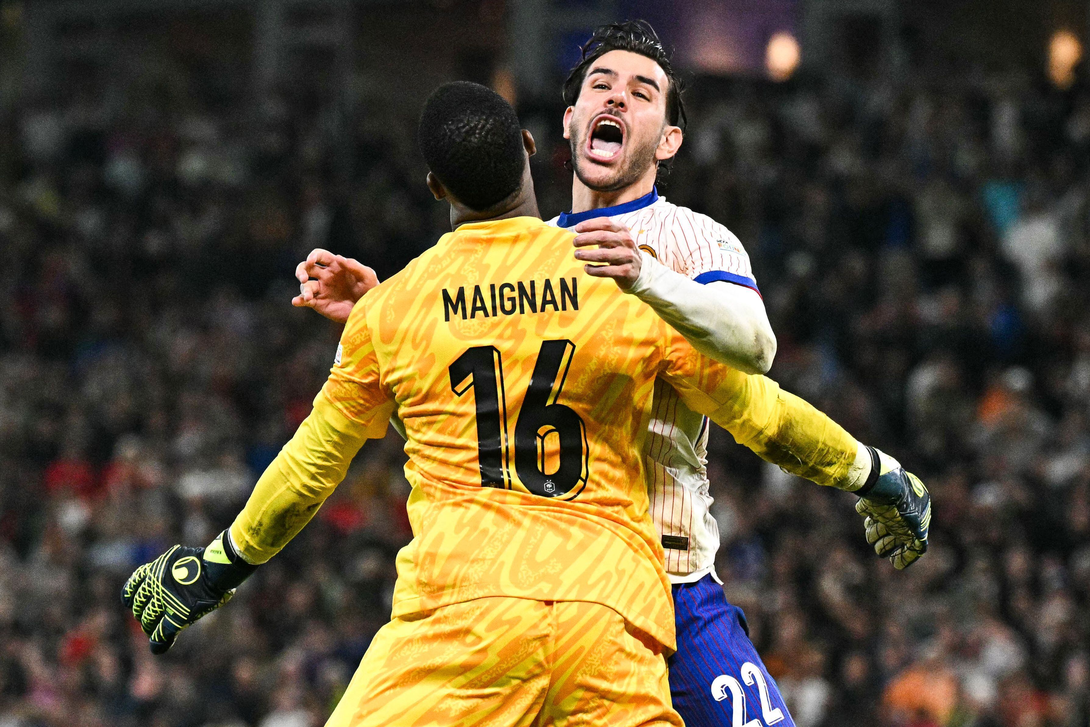 France's defender #22 Theo Hernandez celebrates with France's goalkeeper #16 Mike Maignan after he scored his penalty and qualified France during the UEFA Euro 2024 quarter-final football match between Portugal and France at the Volksparkstadion in Hamburg on July 5, 2024. (Photo by JAVIER SORIANO / AFP)