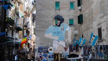 (FILES) In this file photo taken on March 16, 2023 A mural of late Argentinian football legend Diego Maradona is pictured in the Quartieri Spagnoli district of Naples on March 16, 2023. - From narrow streets to balconies, the whole city of Naples is tinged with blue, the colour of its football club which is about to win the Scudetto for the first time since 1990, then with Diego Maradona, who is still revered as a saint today. (Photo by Tiziana FABI / AFP)