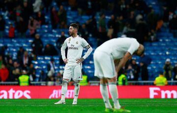 MADRID, SPAIN - JANUARY 06: Sergio Ramos (L) of Real Madrid CF and his teammate Karim Benzema (R) react as he leaves the pitch after loosing the La Liga match between Real Madrid CF and Real Sociedad de Futbol at Estadio Santiago Bernabeu on January 06, 2