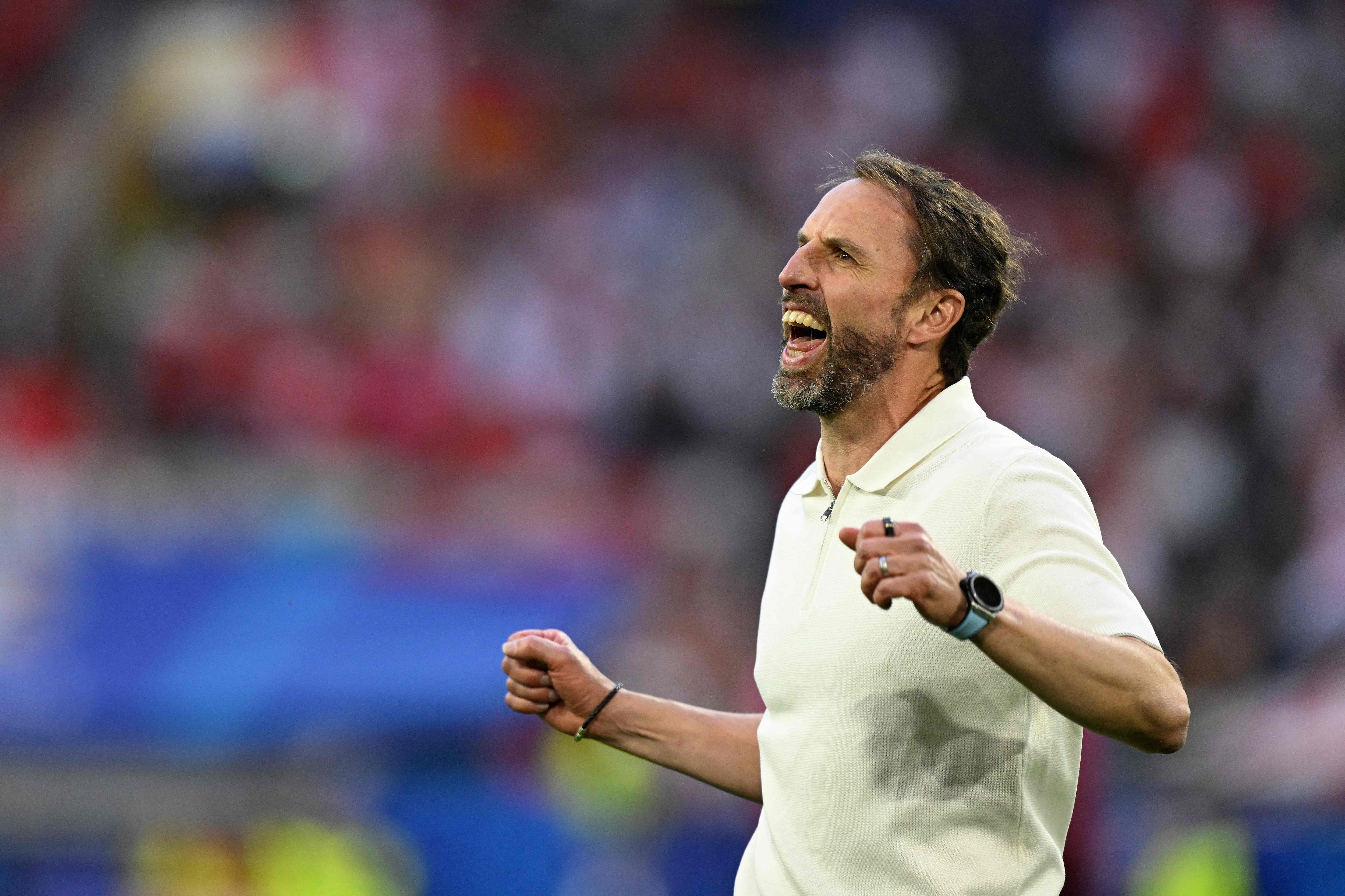 England's head coach Gareth Southgate celebrates after winning the UEFA Euro 2024 quarter-final football match between England and Switzerland at the Duesseldorf Arena in Duesseldorf on July 6, 2024. (Photo by INA FASSBENDER / AFP)