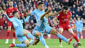 Diogo Jota of Liverpool cuts back whilst under pressure from Aymeric Laporte, Ruben Dias and Joao Cancelo of Manchester City. 