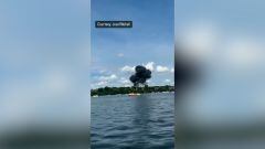 Videos show MiG-23 jet eject its crew just before crash landing into an apartment building parking lot during the Thunder Over Michigan air show.