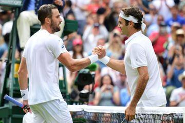 Switzerland's Roger Federer (R) shakes hand with US Steve Johnson after winning the men's singles fourth round match on the eighth day of the 2016 Wimbledon Championships