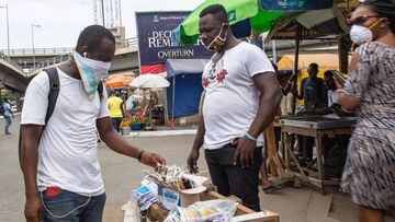 A man sells face masks after the partial lockdown in parts of Ghana to halt the spread of the COVID-19 coronavirus was lifted in Accra, Ghana on April 20, 2020. - The streets of Accra buzzed with life following President Nana Akufo-Addo&#039;s announcemen