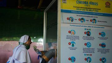 A health official collects nasal and throat swab samples from a nun to test for the Covid-19 coronavirus at a primary health centre  in Siliguri on September 2, 2020. - India on August 30 set a coronavirus record when it reported 78,761 new infections in 