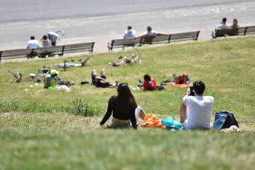 SOUTHEND ON SEA, ENGLAND - MAY 17: People sit and relax on the green opposite the beach to enjoy the sunshine and warm weather.