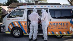 A crew of a private ambulance service in Port Elizabeth wear personal protective equipment (PPE), on July 11, 2020 ahead of checking on a patient affected by COVID-19 coronavirus at her home. (Photo by MARCO LONGARI / AFP)