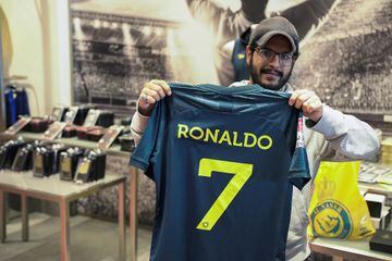 Ronaldomania: a fan holds up an Al Nassr shirt with Cristiano Ronaldo's name on the back. 