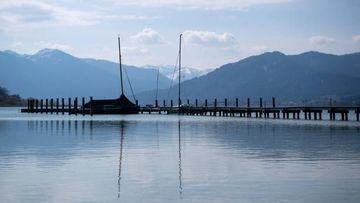 Sailboats are moored at a jetty in the Tegernsee, Germany.