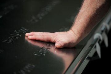 Tom Canavan, who worked on the 47th floor of 1 World Trade Center and was buried alive when the first tower fell on 9/11, touches the engraving with the name of his coworker at the National September 11 Memorial & Museum in New York City, New York, U.S., 