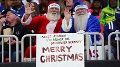 Atlanta Falcons and Indianapolis Colts fans hold up a Merry Christmas sign