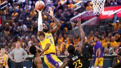May 2, 2023; San Francisco, California, USA; Los Angeles Lakers forward LeBron James (6) makes a shot over Golden State Warriors forward Andrew Wiggins (22) and forward Draymond Green (23) in the second quarter during game one of the 2023 NBA playoffs at the Chase Center. Mandatory Credit: Cary Edmondson-USA TODAY Sports