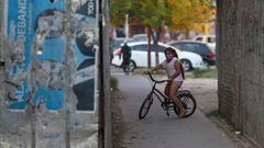 A girl rides her bike while wearing a face mask as the spread of the coronavirus disease (COVID-19) continues, at Fuerte Apache, on the outskirts of Buenos Aires, Argentina April 23, 2020. Picture taken April 23, 2020.  REUTERS/Agustin Marcarian