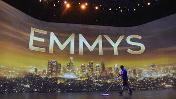 FILE - A crew member sweeps the stage during Press Preview Day for the 71st Primetime Emmy Awards in Los Angeles on Sept. 19, 2019. The Emmy Awards, the first big Hollywood ceremony to attempt a live broadcast amid the pandemic, will be held on Sunday, Se
