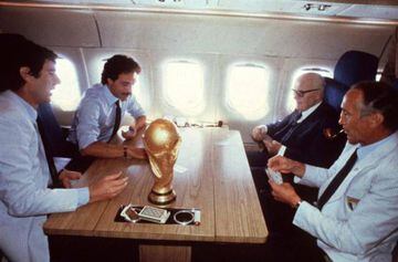 A July 1982 file photo shows the former head coach of the Italian soccer team, Enzo Bearzot (R), while he plays cards on the airplane with Italian President Sandro Pertini (II from R) and Italian goalkeeper Dino Zoff (L) after the victory of the Azzurri's