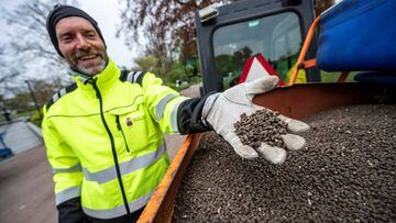 Garden worker Robert Nilsson shows chicken manure with which he fertilises lawns in Stadsparken in an attempt to prevent residents from gathering for the traditional celebrations to mark the Walpurgis Night amid the spread of the coronavirus disease (COVI