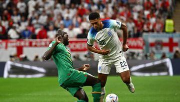 Senegal's defender #03 Kalidou Koulibaly (L) fights for the ball with England's midfielder #22 Jude Bellingham during the Qatar 2022 World Cup round of 16 football match between England and Senegal at the Al-Bayt Stadium in Al Khor, north of Doha on December 4, 2022. (Photo by Anne-Christine POUJOULAT / AFP) (Photo by ANNE-CHRISTINE POUJOULAT/AFP via Getty Images)