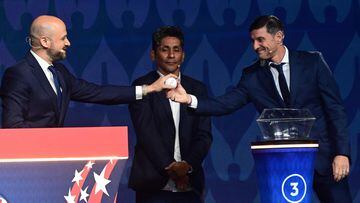 Argentine former football player Javier Zanetti (R) picks up a ball from the pot and hands it over toC ONCACAF's Chief Football Competitions Officer Carlos Fernandez (L) during the final draw for the Conmebol Copa America 2024 football competition at the James L. Knight Centre in Miami, Florida, on December 7, 2023. (Photo by GIORGIO VIERA / AFP)