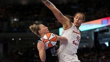 (FILES) In this file photo taken on October 17, 2021, Courtney Vandersloot (L) of the Chicago Sky drives to the basket against Brittney Griner of the Phoenix Mercury during Game Four of the WNBA Finals in Chicago, Illinois. NOTE TO USER: User expressly ac
