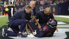 HOUSTON, TX - OCTOBER 25: Will Fuller #15 of the Houston Texans is tended to by the training staff in the fourth quarter against the Miami Dolphins at NRG Stadium on October 25, 2018 in Houston, Texas.   Tim Warner/Getty Images/AFP == FOR NEWSPAPERS, INTERNET, TELCOS &amp; TELEVISION USE ONLY ==