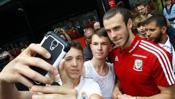 Wales player Gareth Bale signs autographs.
