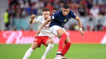 DOHA, QATAR - DECEMBER 04: Kylian Mbappe of France battles for possession with Matty Cash of Poland during the FIFA World Cup Qatar 2022 Round of 16 match between France and Poland at Al Thumama Stadium on December 04, 2022 in Doha, Qatar. (Photo by Laurence Griffiths/Getty Images)