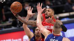 DENVER, COLORADO - MAY 22: Damian Lillard #0 of the Portland Trail Blazers goes to the basket against Facundo Campazzo #7 and Nikola Jokic #15 of the Denver Nuggets in the fourth quarter during Game One of their Western Conference first-round playoff seri