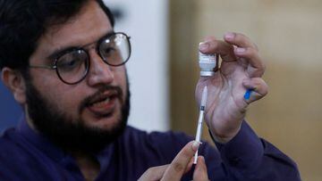A healthcare worker prepares a dose of Moderna coronavirus disease  vaccine at a vaccination centre in Karachi, Pakistan.