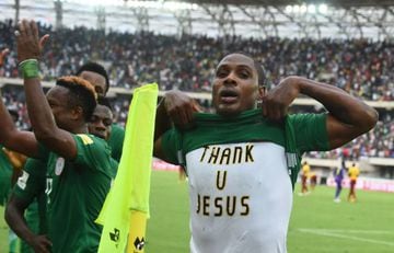 Nigerian striker Odion Ighalo pulls up his jersey to show his tshirt reading "thank u Jesus" after scoring a goal against Cameroon during the 2018 FIFA World Cup qualifying football match between Nigeria and Cameroon at Godswill Akpabio International Stad