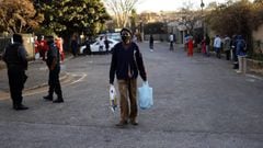 Johannesburg (South Africa), 06/08/2020.- A man walks away after receiving food during the weekly feeding scheme at the Heritage Baptist Church amid the coronavirus emergency lockdown in Melville, Johannesburg, South Africa, 06 August 2020. Volunteers fro