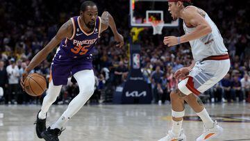 Kevin Durant #35 of the Phoenix Suns drives against Aaron Gordon #50 of the Denver Nuggets