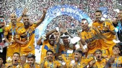 Tigres' Brazilian defender Samir de Souza (C, left) and Uruguayan forward Nicolas Lopez (C, right) raise the trophy after winning the Mexican Clausura football tournament by defeating Guadalajara 3-2 in extra-time of the second leg final match at Akron Stadium in Zapopan, Jalisco State, Mexico, on May 28, 2023. (Photo by ULISES RUIZ / AFP)