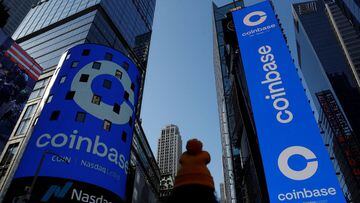 FILE PHOTO: The logo for Coinbase Global Inc, the biggest U.S. cryptocurrency exchange, is displayed on the Nasdaq MarketSite jumbotron and others at Times Square in New York, U.S., April 14, 2021. REUTERS/Shannon Stapleton/File Photo