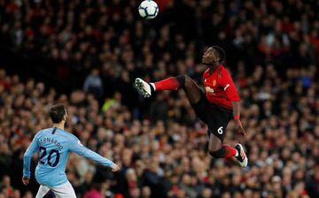 Manchester United's Paul Pogba leaps to control a high ball in the derby.