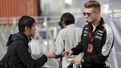 Force India driver Nico Hulkenberg of Germany signs his autograph for a fan ahead of the first practice session for the Japanese Formula One Grand Prix at the Suzuka International Circuit in Suzuka, Japan, Friday, Oct. 7, 2016. (AP Photo/Eugene Hoshiko)