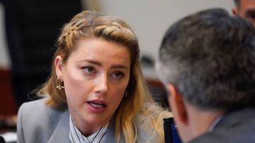 Actor Amber Heard speaks to her legal team as they arrive for closing arguments in the Depp v. Heard trial at the Fairfax County Circuit Courthouse in Fairfax, Virginia, on May 27, 2022. - Actor Johnny Depp is suing ex-wife Amber Heard for libel after she wrote an op-ed piece in The Washington Post in 2018 referring to herself as a public figure representing domestic abuse. (Photo by Steve Helber / POOL / AFP) (Photo by STEVE HELBER/POOL/AFP via Getty Images)