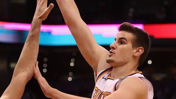 PHOENIX, AZ - DECEMBER 31: Dragan Bender #35 of the Phoenix Suns attempts a shot over Dario Saric #9 of the Philadelphia 76ers during the first half of the NBA game at Talking Stick Resort Arena on December 31, 2017 in Phoenix, Arizona. The 76ers defeated