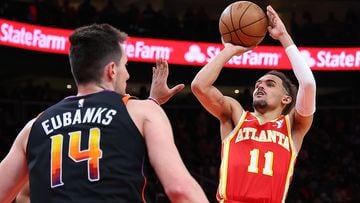 ATLANTA, GEORGIA - FEBRUARY 02: Trae Young #11 of the Atlanta Hawks attempts a shot against Josh Okogie #2 of the Phoenix Suns during the fourth quarter at State Farm Arena on February 02, 2024 in Atlanta, Georgia. NOTE TO USER: User expressly acknowledges and agrees that, by downloading and/or using this photograph, user is consenting to the terms and conditions of the Getty Images License Agreement.   Kevin C. Cox/Getty Images/AFP (Photo by Kevin C. Cox / GETTY IMAGES NORTH AMERICA / Getty Images via AFP)