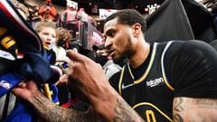 PORTLAND, OREGON - FEBRUARY 24: Gary Payton II #0 of the Golden State Warriors signs autographs for fans after the game against the Portland Trail Blazers at the Moda Center on February 24, 2022 in Portland, Oregon. The Golden State Warriors won 132-95. N