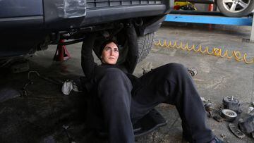 TEHRAN, IRAN - MARCH 05: Female auto mechanics 31 year-old Kiyana Yarahmadi and her friend 32 year-old Nilufar Farahmand (not seen), repair the car at a car service ahead of the International Women's Day in Tehran, Iran on March 05, 2023. Women mechanics, who stated that they had difficulties in starting the profession because it is considered more of a men's job, dream of working with leading automobile companies. Kiyana and Nilufar, who set an example for many women who want to be mechanics in the country, aim to gain experience abroad to improve themselves. (Photo by Fatemeh Bahrami/Anadolu Agency via Getty Images)