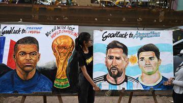Students adjust paintings of Argentina's forward Lionel Messi and France's forward Kylian Mbapp� ahead of the Qatar 2022 FIFA World Cup football final match between France and Argentina, at an art school in Mumbai on December 16, 2022. (Photo by Punit PARANJPE / AFP)