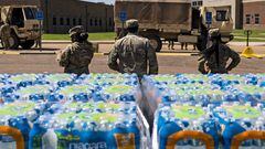 JACKSON, MS - SEPTEMBER 01: Members of the Mississippi National Guard hand out bottled water at Thomas Cardozo Middle School in response to the water crisis on September 01, 2022 in Jackson, Mississippi. Jackson has been experiencing days without reliable water service after river flooding caused the main treatment facility to fail. (Photo by Brad Vest/Getty Images)