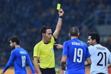 Germany's midfielder Ilkay Gundogan (R) receives a yellow card from referee Artur Soares Dias (C) during the International friendly football match Italy vs Germany on November 15, 2016 at the 'San Siro Stadium' in Milan.  / AFP PHOTO / GIUSEPPE CACACE